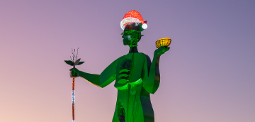 Lina lit up at night in green with a santa light hat